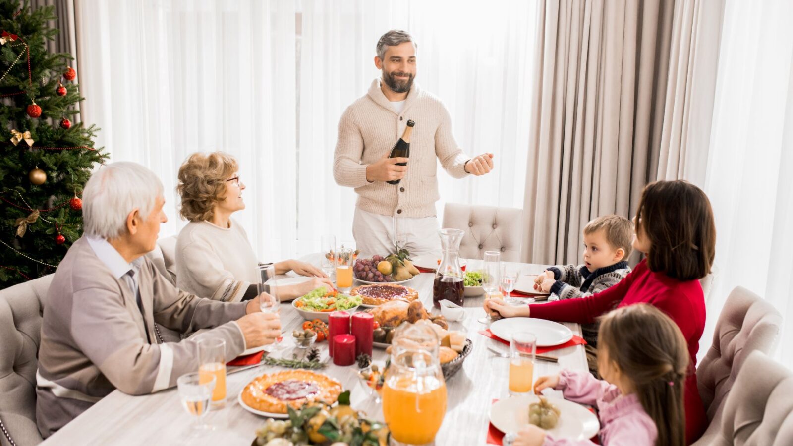 family celebrating christmas at table